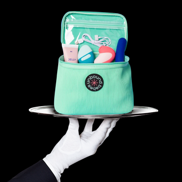 sex toy storage case displayed on a silver platter held by a white gloved hand